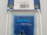 a close up of a package of screws on a white surface