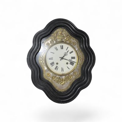 a black and gold clock with roman numerals on it