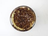 a close up of a cup of coffee on a white table