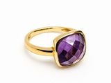 a close up of a gold ring with an amethorate stone