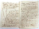 an old book with writing on it sitting on top of a table