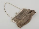 an antique silver mesh purse with chain strap and clasp