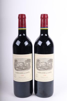 deux bouteilles de vin rouge posées l'une à côté de l'autre sur une surface blanche