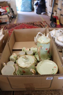 a box full of tea cups and saucers on the floor
