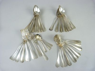 three silver spoons and a fork on a white surface