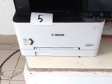 a printer sitting on top of a stack of boxes