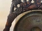 a bronze statue of a dragon holding a gong