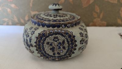 a blue and white teapot sitting on a table