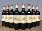 six bottles of wine are lined up in a row on a table