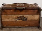 a wooden box with a handle on it on a wooden floor