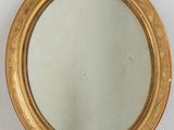an image of a gold framed mirror sitting on top of a white shelf
