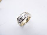 a close up of a diamond ring on a white surface