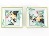 pair of hand painted ceramic trays with toucans on them