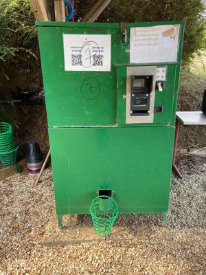 a green machine that is sitting in the dirt