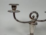 a silver candelab with two candles on it