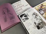 an open book with a drawing of a woman in a dress