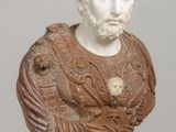 marble bust of a man with a beard, wearing a brown and white dress