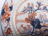 a plate with a picture of a bird and flowers on it
