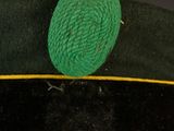 a ball of yarn on top of a green hat