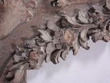 a close up of a carved wood frame with flowers