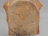 an image of a brown plate with a circular design on it