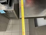 a measuring tape on the floor of a commercial kitchen
