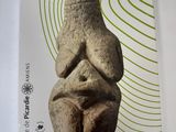 a picture of a book with a statue on it