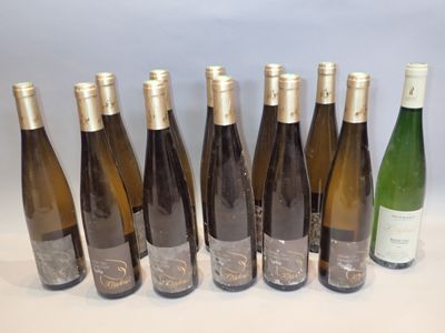 six bottles of wine are lined up in a row on a table