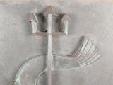a close up of a metal door with a bird on it