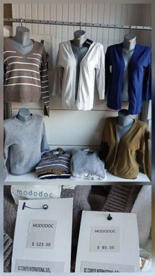 a closet full of clothes and clothing items on display