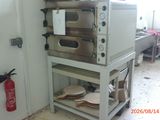a stack of ovens sitting on a cart in a kitchen