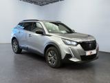 the silver suv is parked in a white room with a black floor