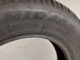 a close up of a tire on a white surface
