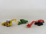 four toy construction vehicles that are on a white surface