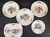 four plates with pictures of people on them sitting on a table