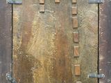 a picture of an old wooden door with a metal latch