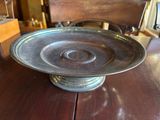 a metal plate sitting on a wooden table