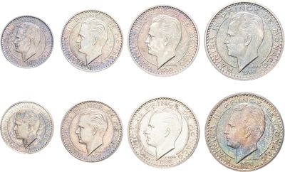 a close up of a bunch of coins with different faces