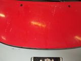a close up of a red car with a license plate on it