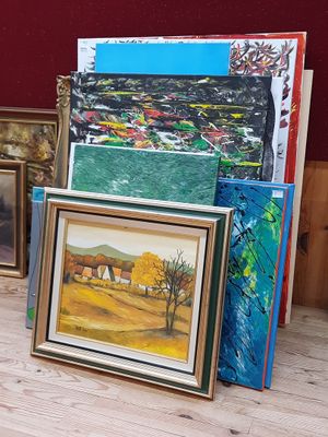 a lot of paintings that are sitting on the floor