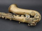 an old saxophone sitting on top of a black surface