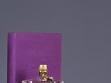 bottles of perfume are sitting on a shelf next to a purple box