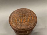 a small wooden box with a design on it