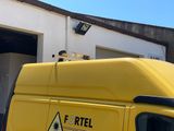 a yellow van that is parked in front of a building