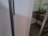 two white refrigerators in a kitchen next to a staircase