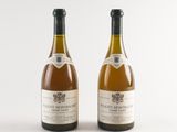 two bottles of wine sitting next to each other on a white surface