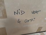 a cardboard box with writing on it sitting on the floor