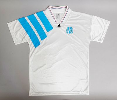 a white shirt with blue and white stripes on the chest