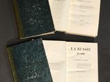 three books are sitting on top of each other on a table