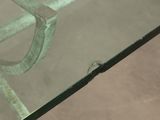 a glass table with a metal frame and a glass top